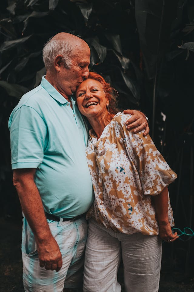 Happy older couple sharing a warm hug in a welcoming senior residence in East China, MI — celebrating connection and quality moments in a supportive retirement setting.